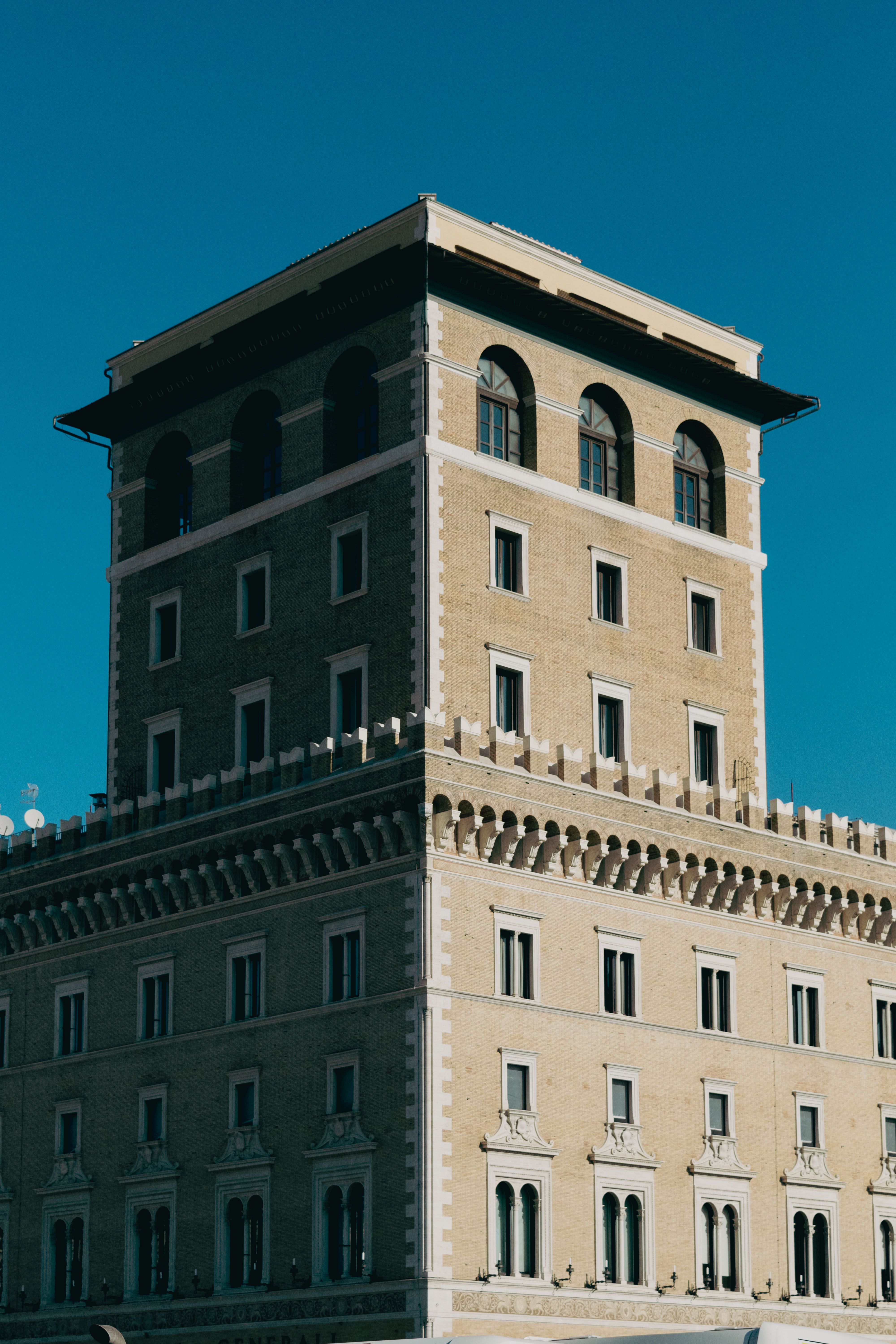 A classic Roman architecture under a clear blue sky in Rome, Italy, exhibiting historical grandeur.