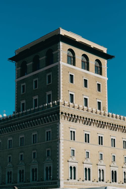 Free A classic Roman architecture under a clear blue sky in Rome, Italy, exhibiting historical grandeur. Stock Photo