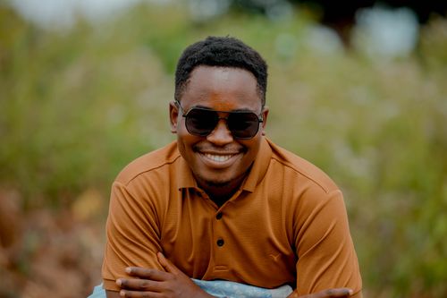 Free A cheerful man wearing sunglasses poses outdoors in Homa Bay, Kenya. Stock Photo