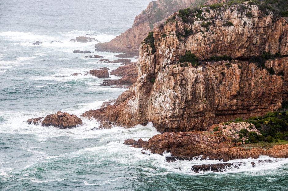 Incredible One Day Cape of Good and Penguin Colony Expedition from Cape Town Review 2026 - Waves crash against the rugged cliffs of the South African shoreline, showcasing nature's raw beauty.