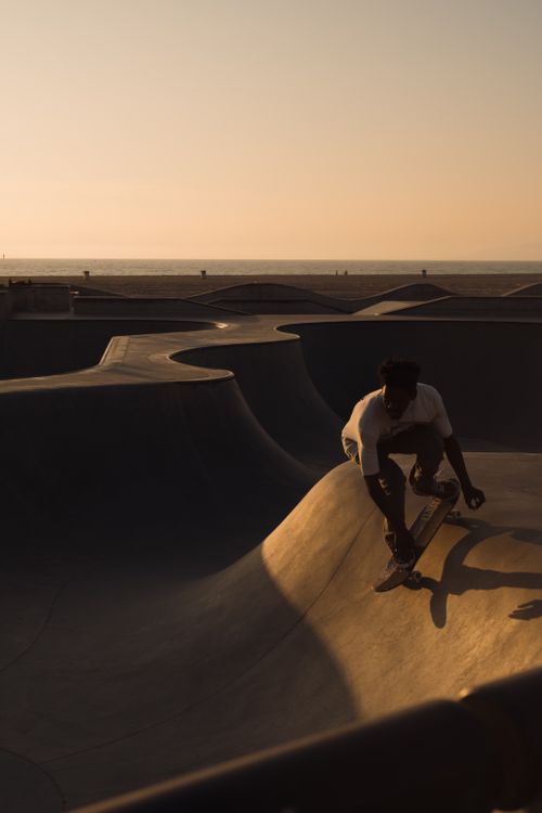 Free Silhouette of a skateboarder at sunset in a Los Angeles skatepark, capturing urban lifestyle. Stock Photo