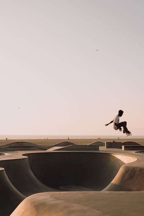 Free A skateboarder performs a jump at the iconic Venice Beach Skatepark in Los Angeles. Stock Photo