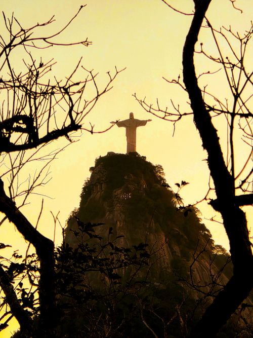 Free Stunning view of Christ the Redeemer statue silhouetted against a vibrant sunset in Rio de Janeiro. Stock Photo