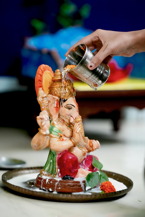 Free Vibrant Ganesh idol being anointed during Ganesh Chaturthi celebration in Kolkata, India. Stock Photo