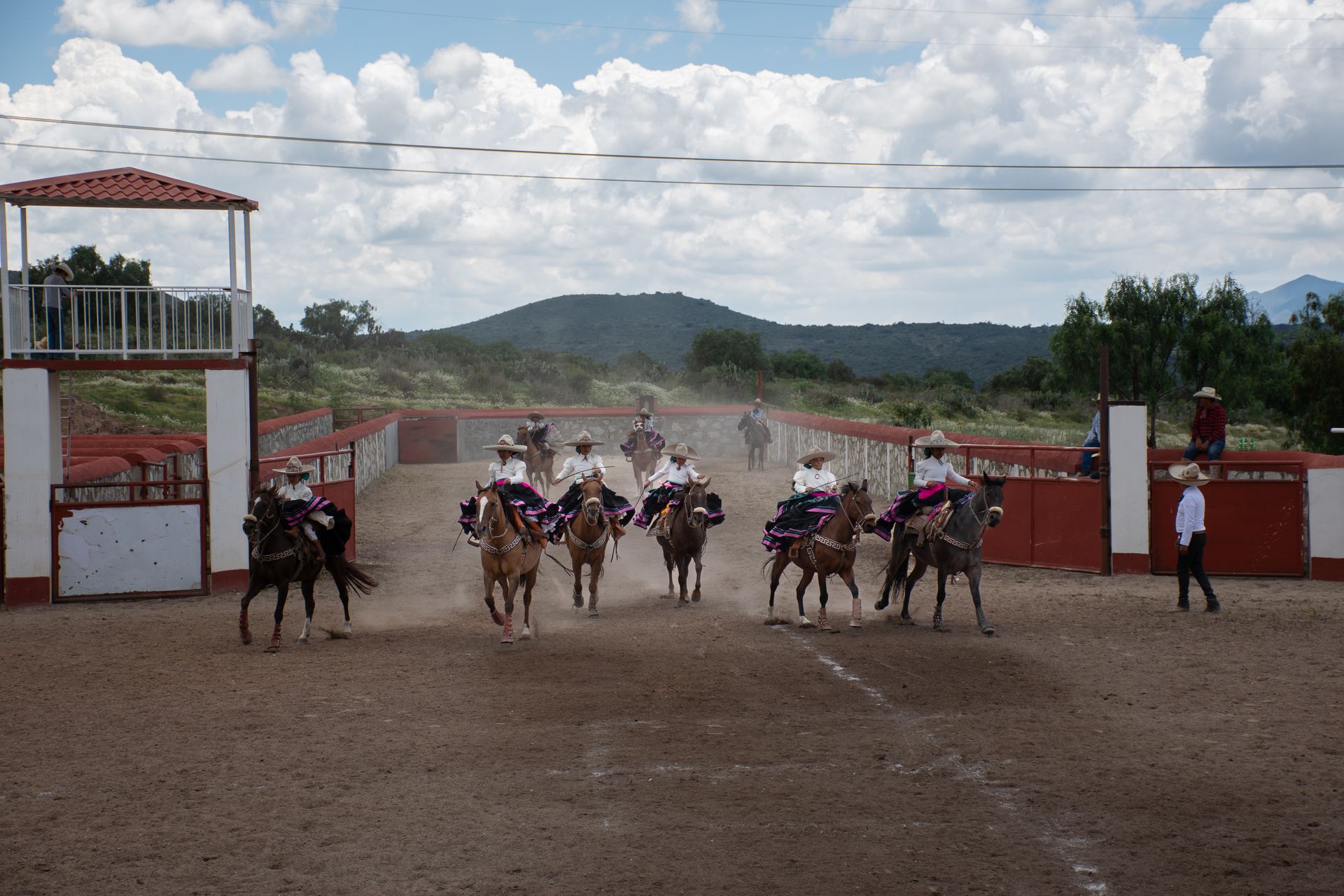Lively scene of a traditional charreada, showcasing Mexican horse riding skills.