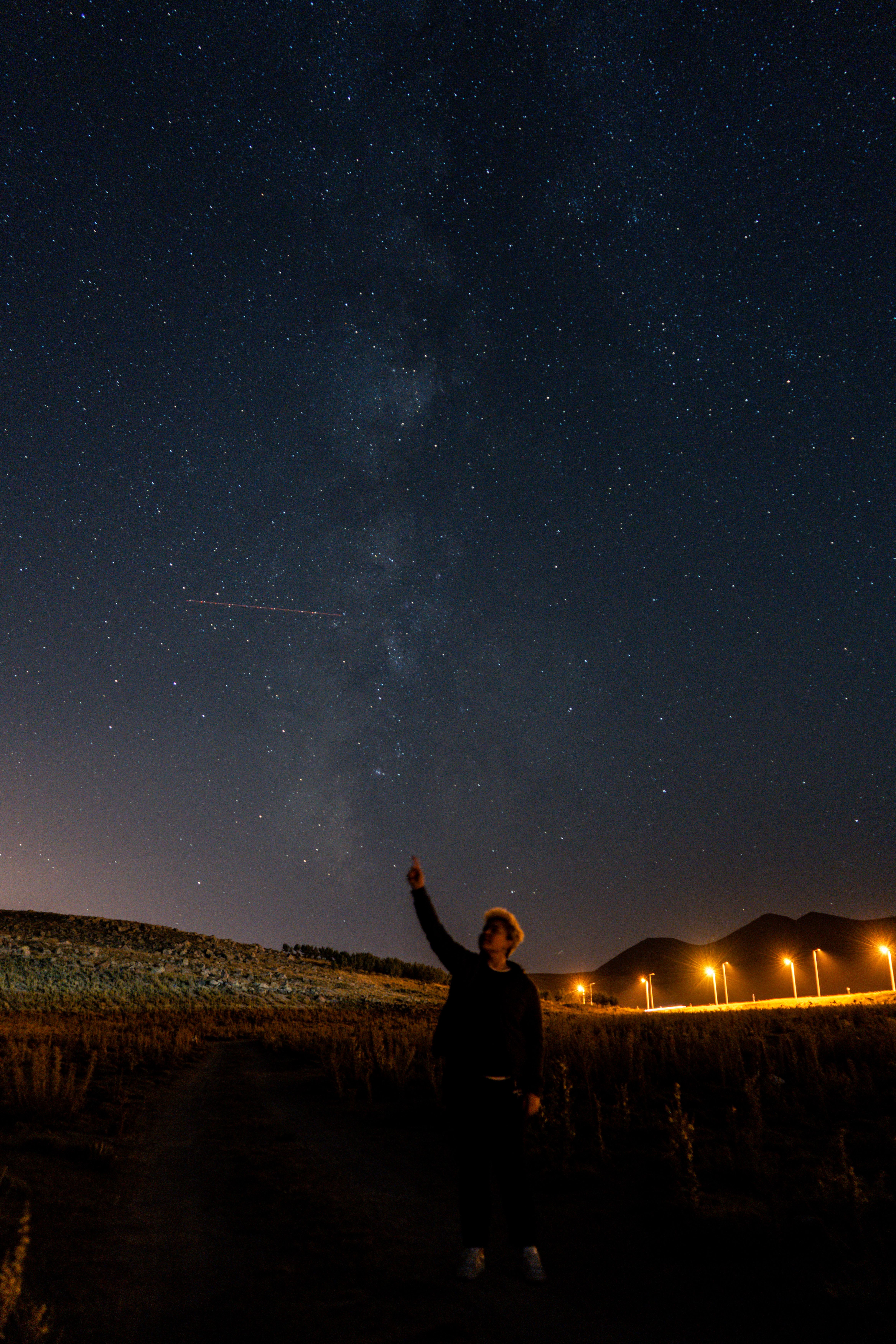 person watching night sky open field