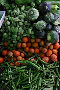 Vibrant display of green and red vegetables, showcasing freshness and variety.