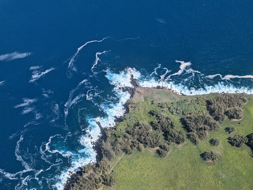 Spectacular Kona Coast Hualalai Volcano-60Min Helicopter Tour-Door Off or On Review Review 2026 - Stunning aerial photo of Hawaii's vibrant coastline with crashing waves and lush greenery.