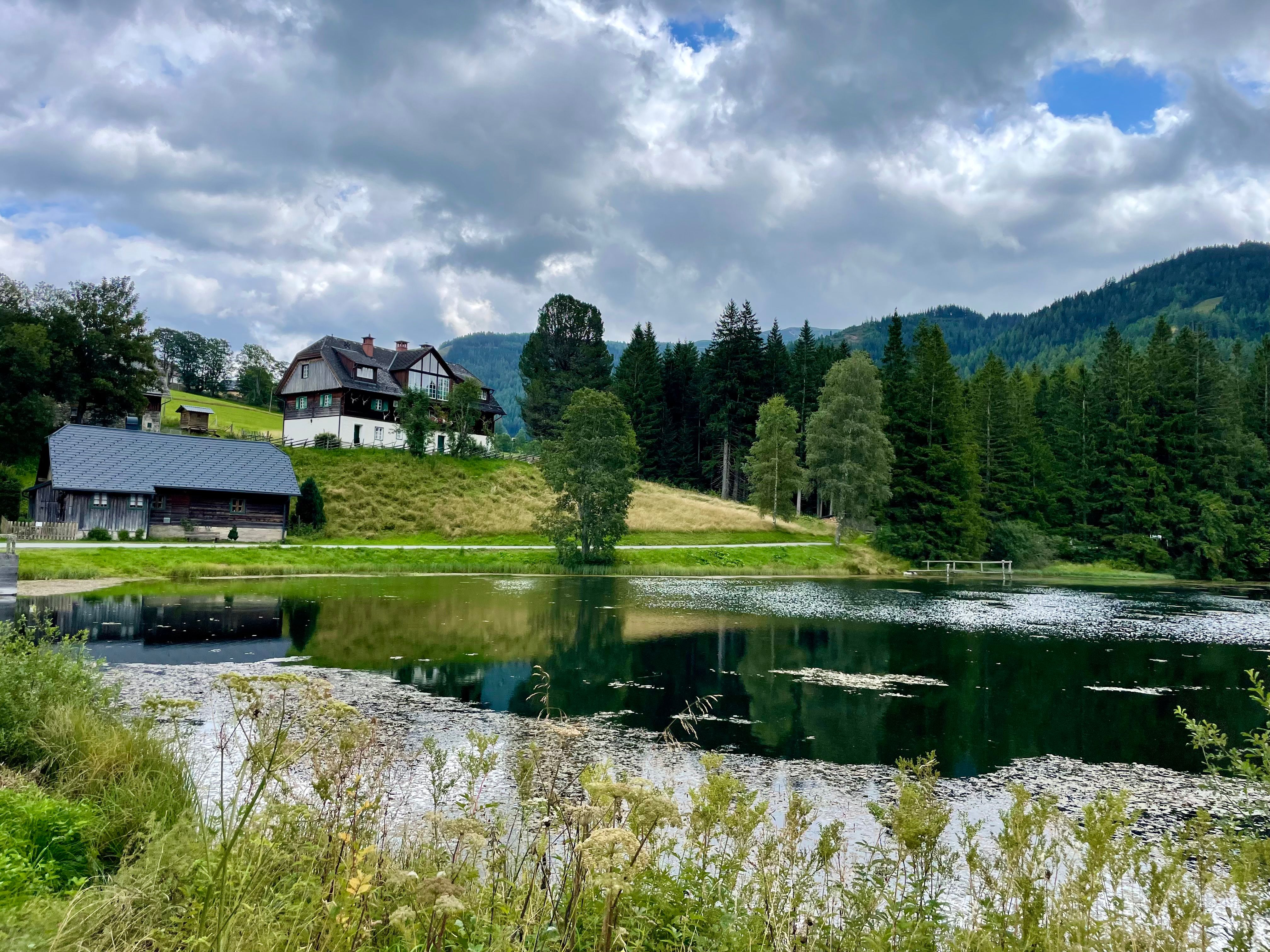 Picturesque Hohentauern, Austria, with idyllic lake, lush greenery, and rustic houses.