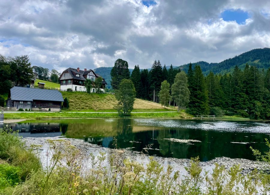 Picturesque Hohentauern, Austria, with idyllic lake, lush greenery, and rustic houses.