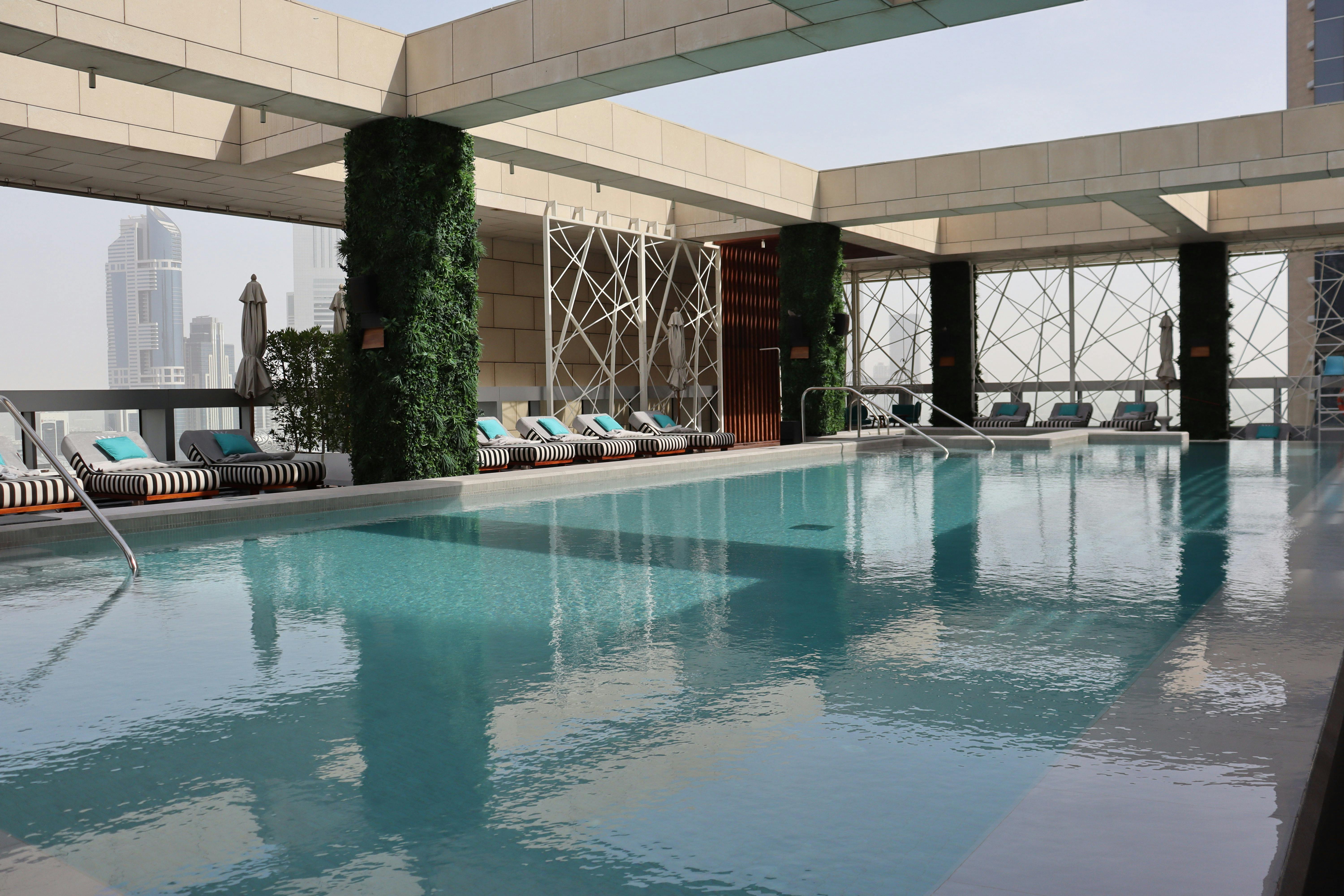 Elegant rooftop pool in Dubai with city skyline views, perfect for relaxation.