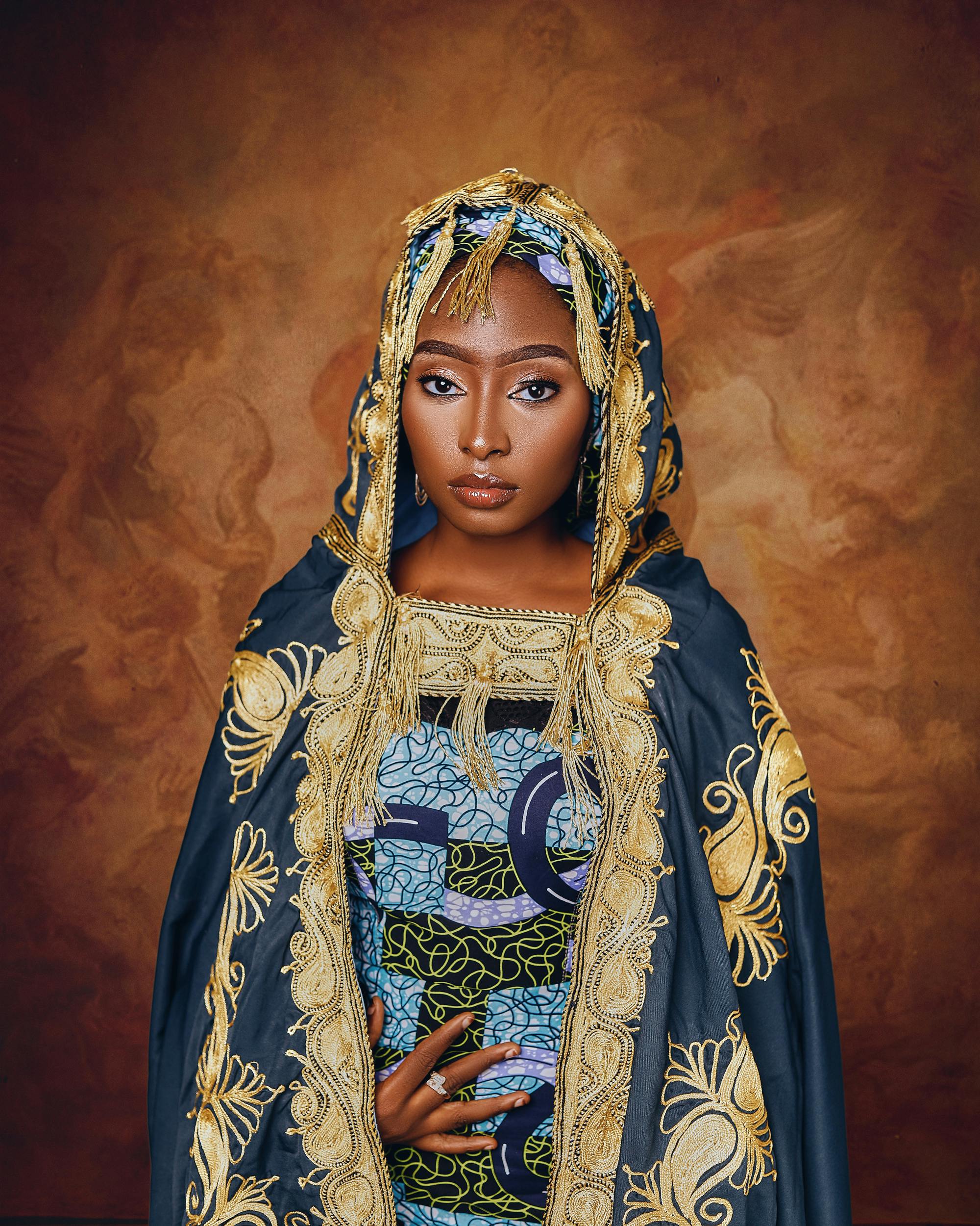 Portrait of an African woman in ornate traditional clothing, exuding grace and poise.