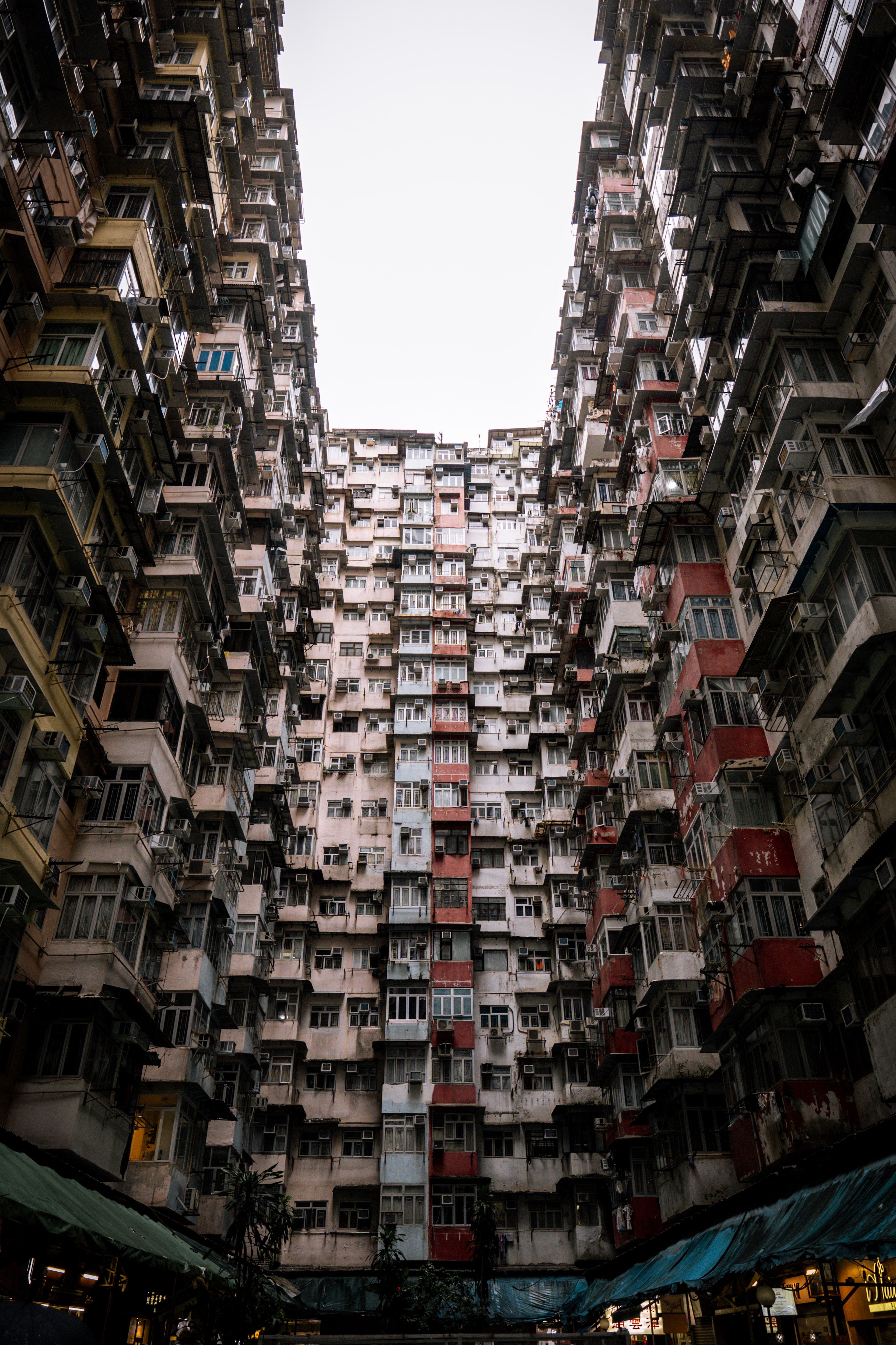 Looking up at the crowded architecture of a vibrant urban apartment block.