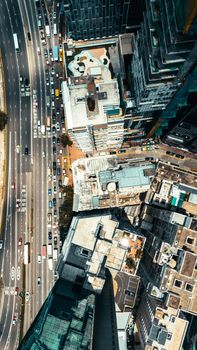 Stunning aerial shot of a bustling cityscape with skyscrapers and highway traffic below.