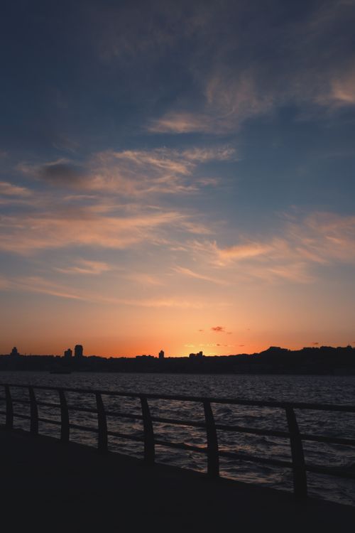 Free Beautiful sunset over the Bosphorus in İstanbul with silhouetted cityscape and vivid sky. Stock Photo