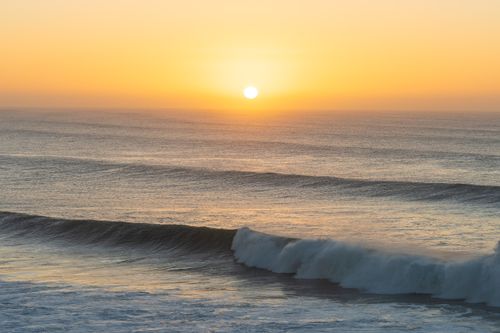Free Golden sunrise over the waves at Bells Beach, a serene moment captured. Stock Photo