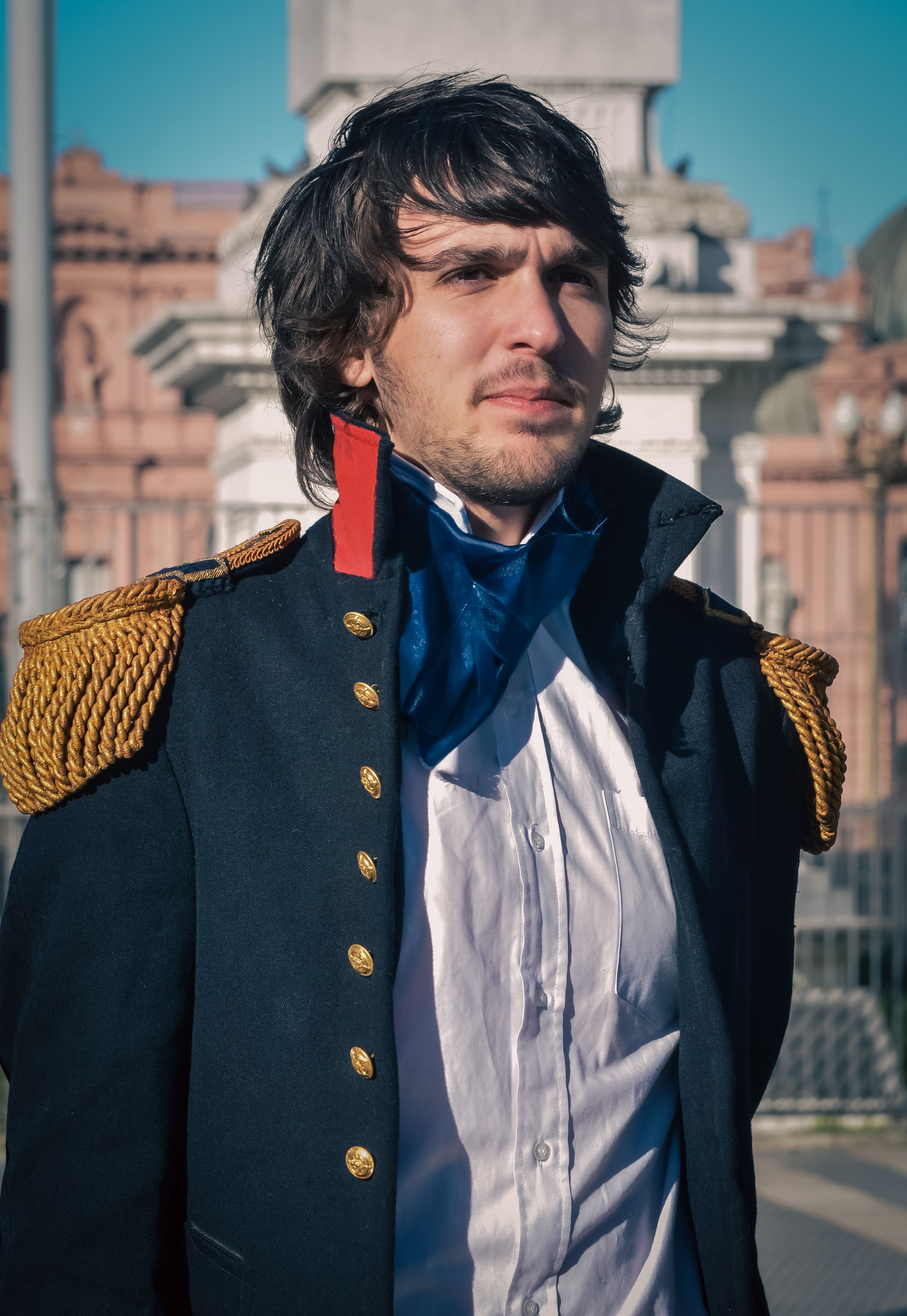 Portrait of a man in a historical costume at a landmark in Buenos Aires, Argentina.