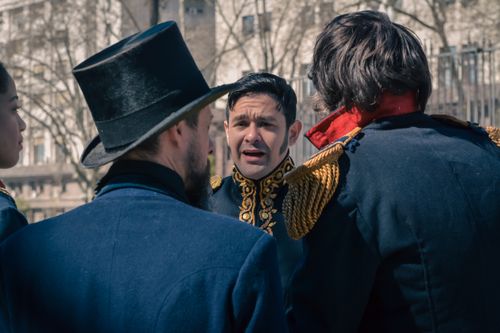 Free Group of historical reenactors in period military costumes outdoors during daytime. Stock Photo