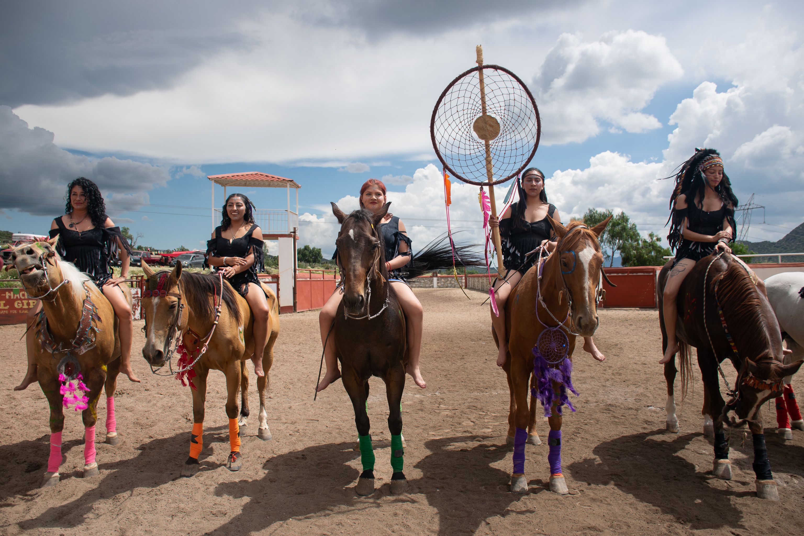Women in Traditional Attire Riding Horses, Dreamcatcher in Background ...
