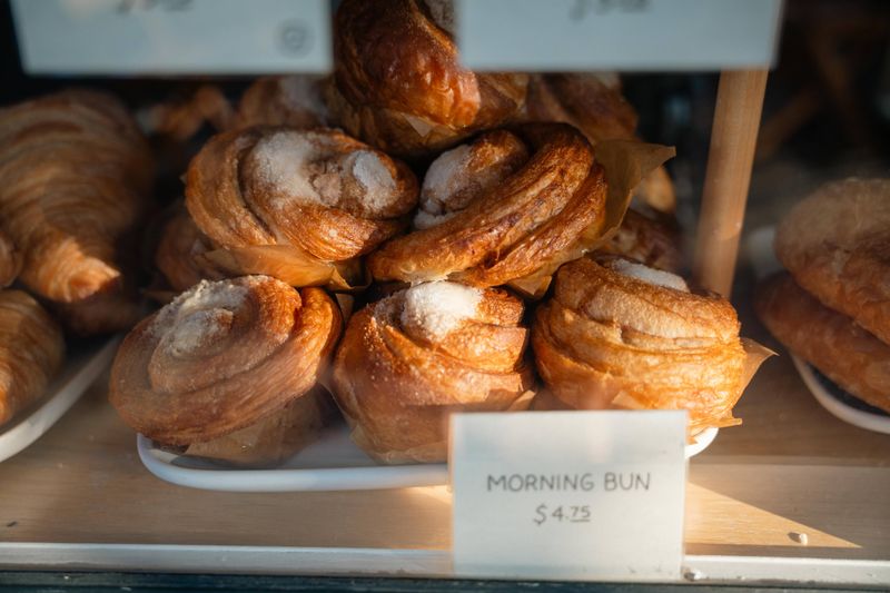Sugar-topped buns in a bakery display
