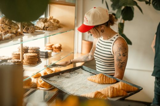 Baker arranging croissants, photo by James Collington on Pexels