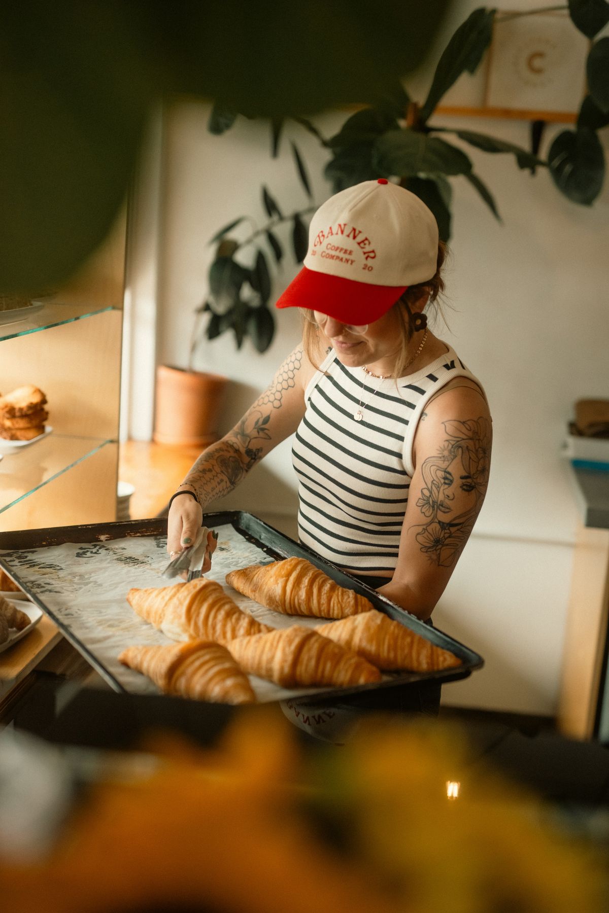 Baker holding a tray of fresh croissants