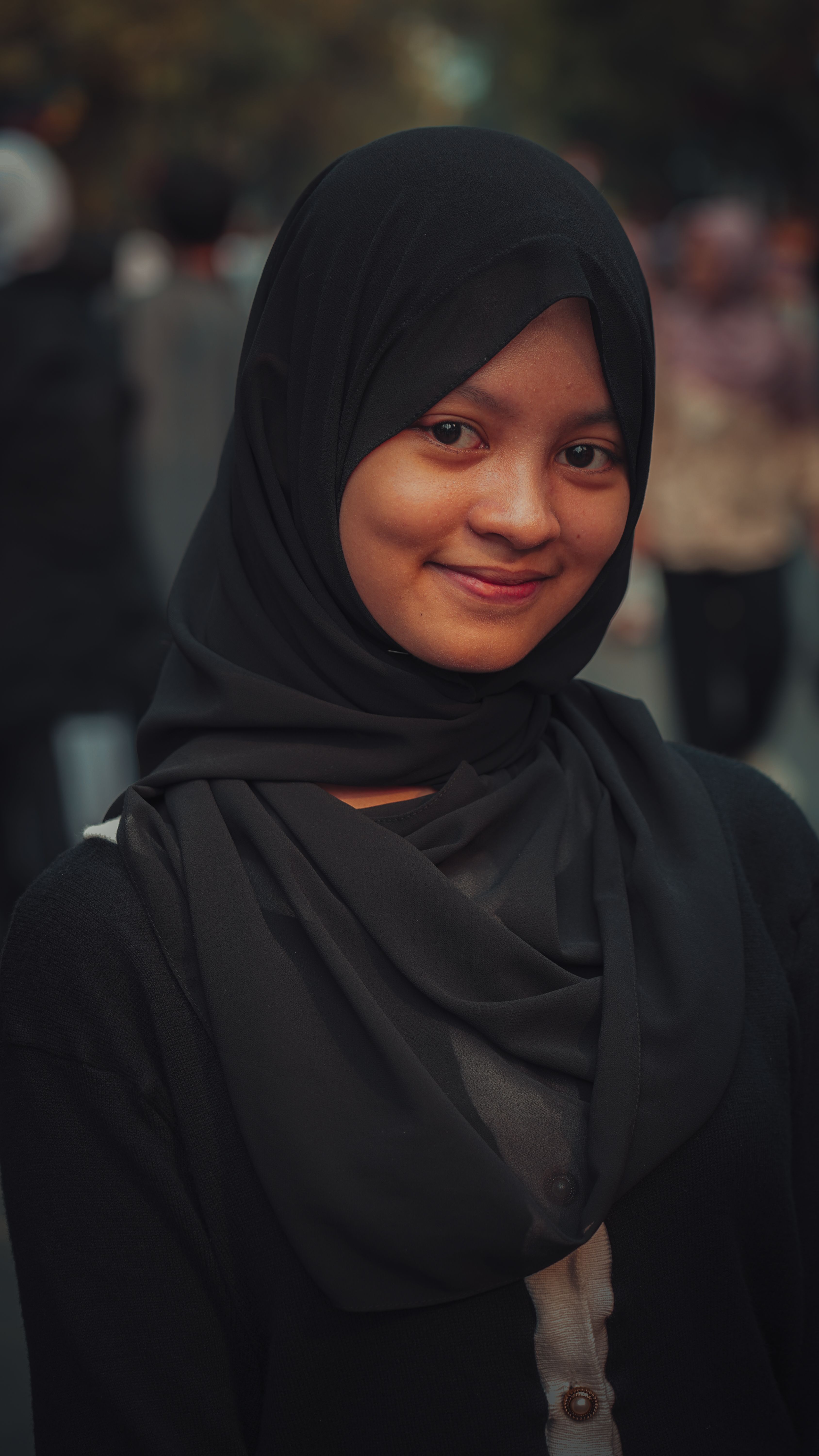 Smiling Woman Wearing Black Hijab Outdoors