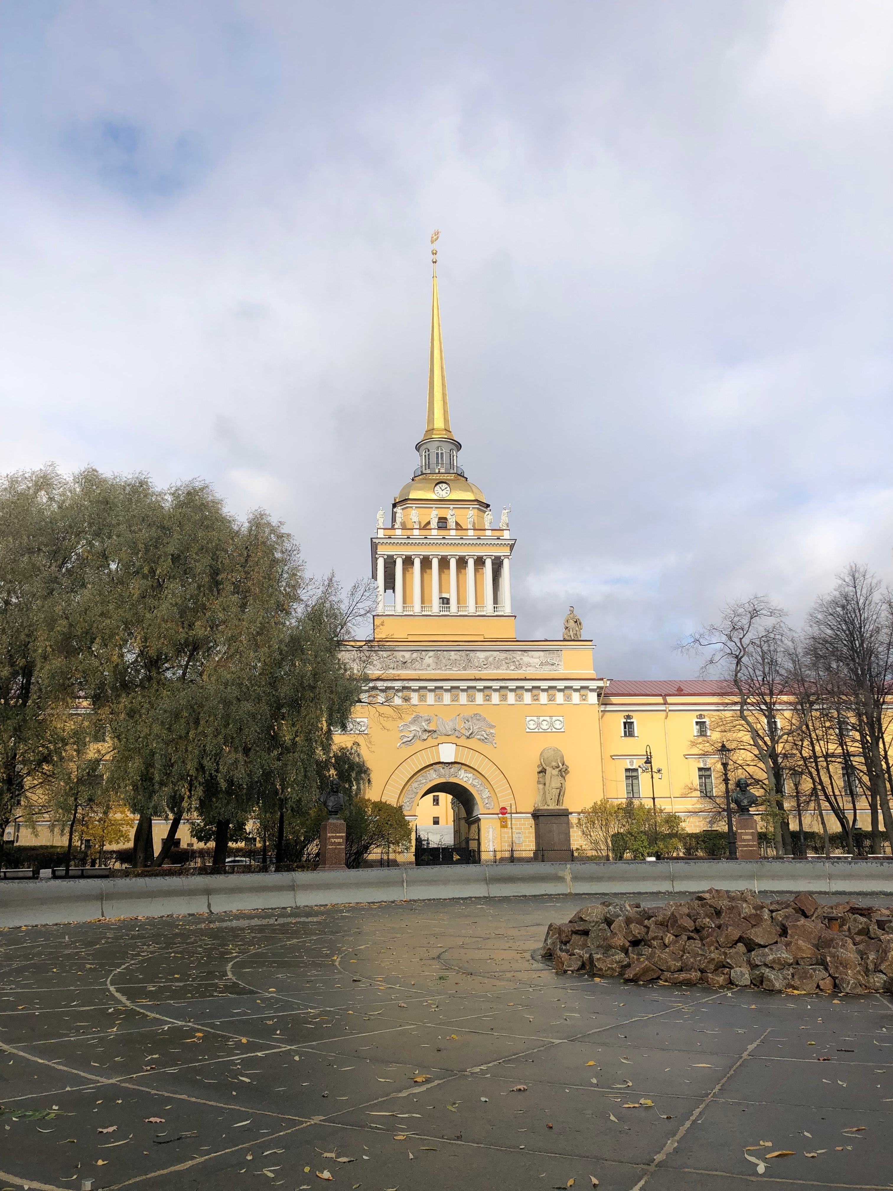 The Admiralty Building in Saint Petersburg under a cloudy sky, featuring its iconic golden spire.