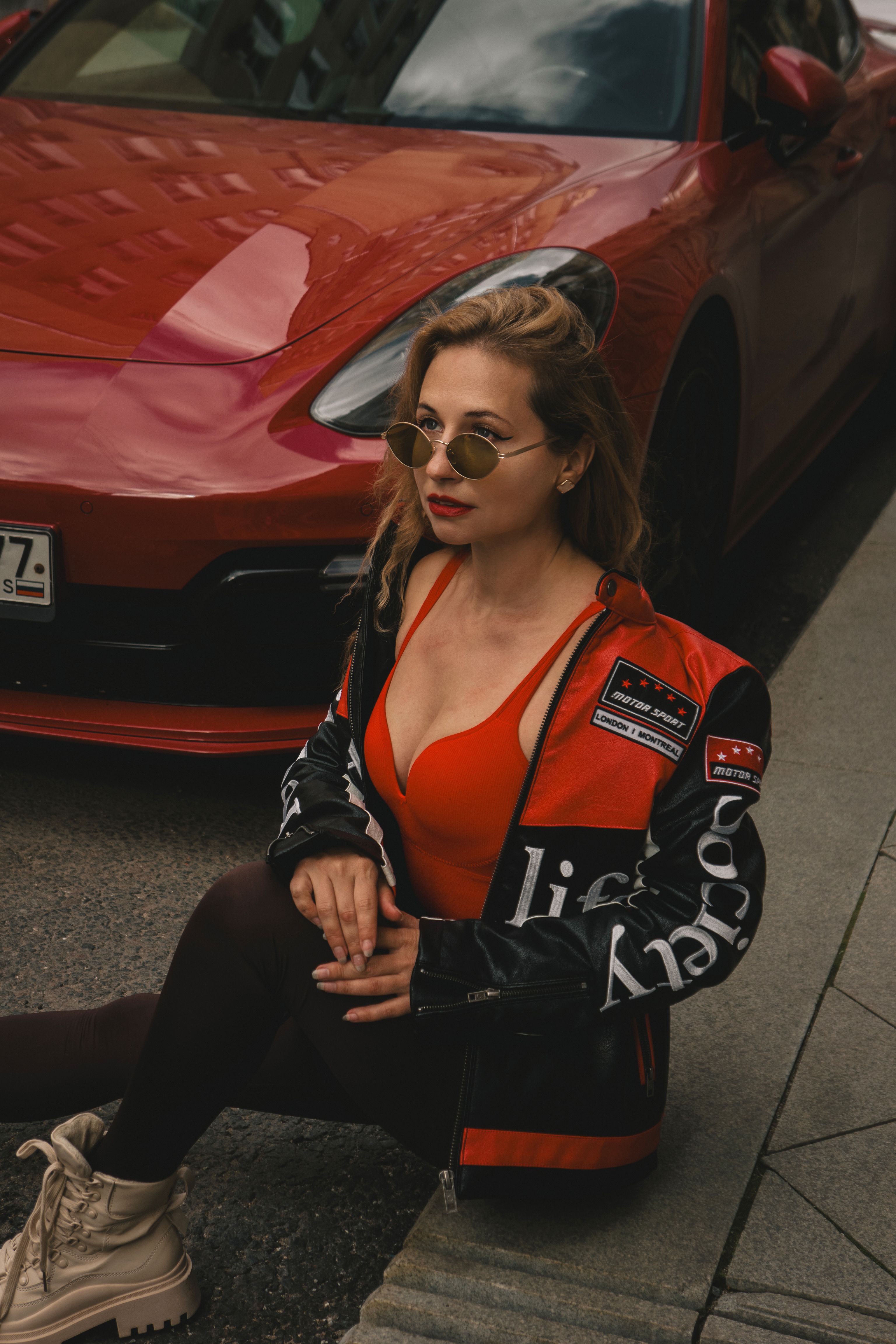 Stylish Woman Posing Next to Red Sports Car · Free Stock Photo