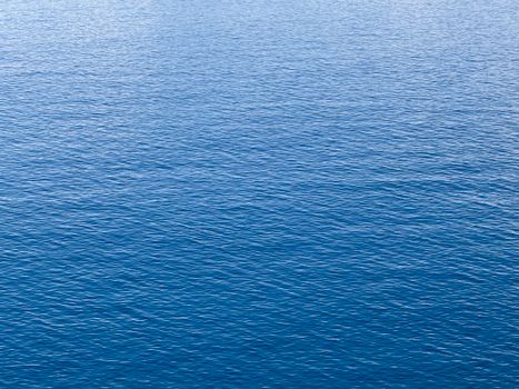 A serene view of the blue ocean surface, capturing the tranquility and endless horizon.