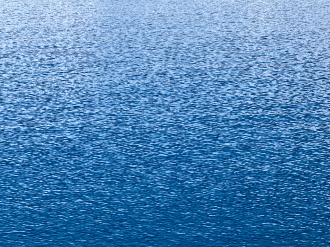 a serene view of the blue ocean surface capturing the tranquility and