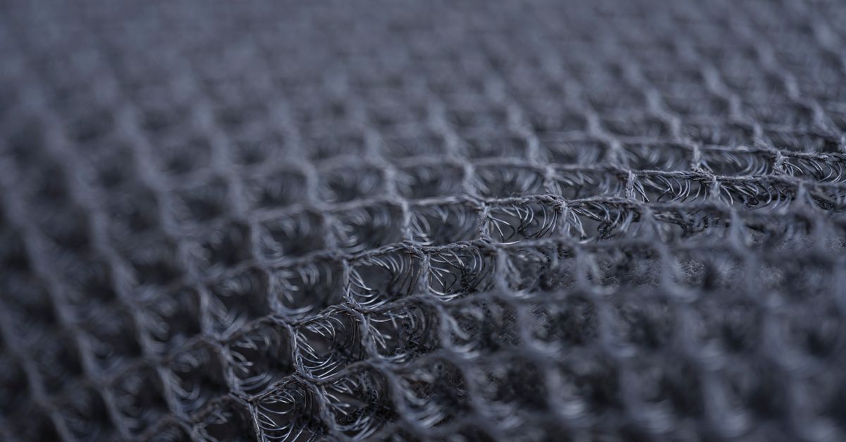 Detailed macro shot of a textured synthetic fabric with intricate patterns.