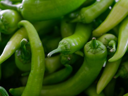 Free Vibrant fresh green chili peppers in a close-up shot ideal for food and organic produce themes. Stock Photo