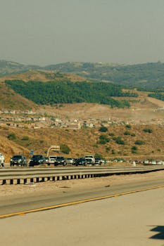 A busy highway with vehicles against a mountain backdrop in San Diego, California.