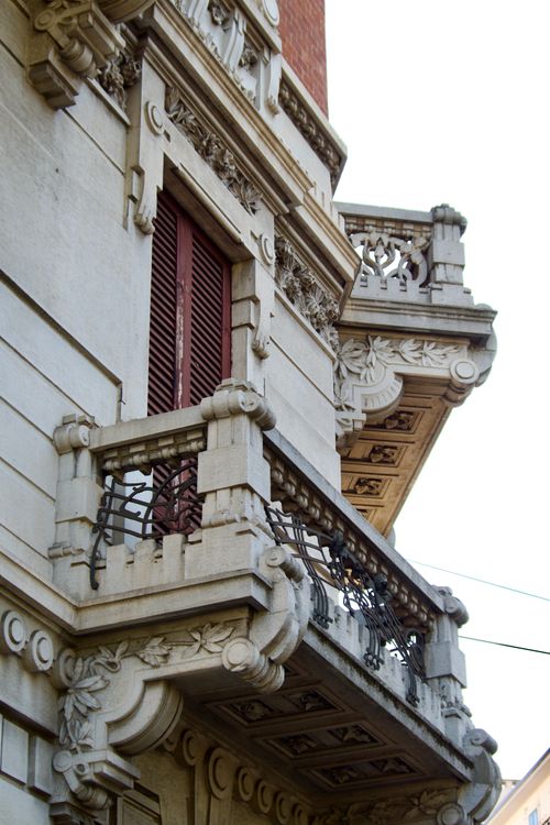 Free Close-up of an ornate European-style balcony with intricate carvings and wrought iron. Stock Photo
