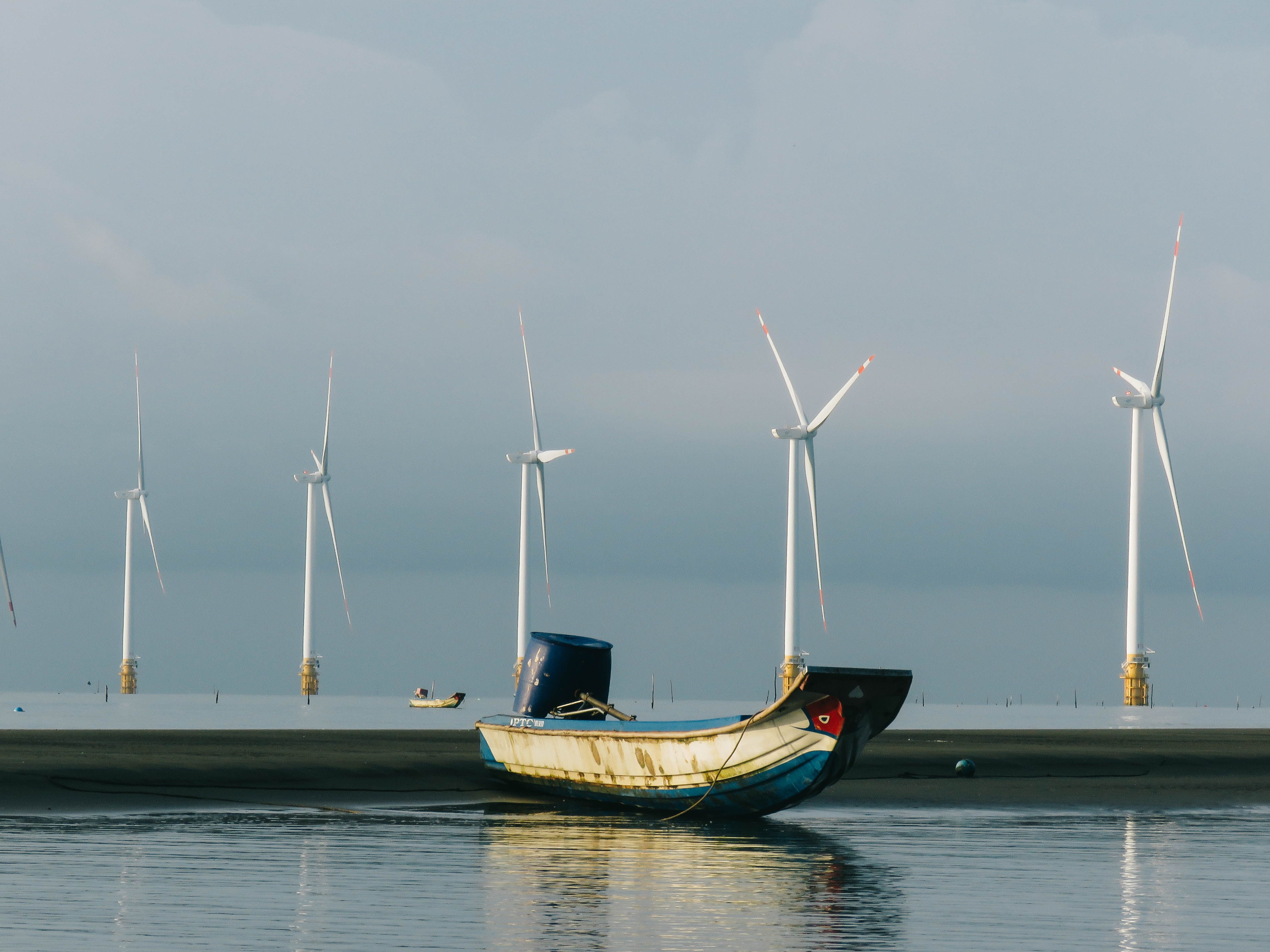 Fishing Boat with Wind Turbines at Sea · Free Stock Photo