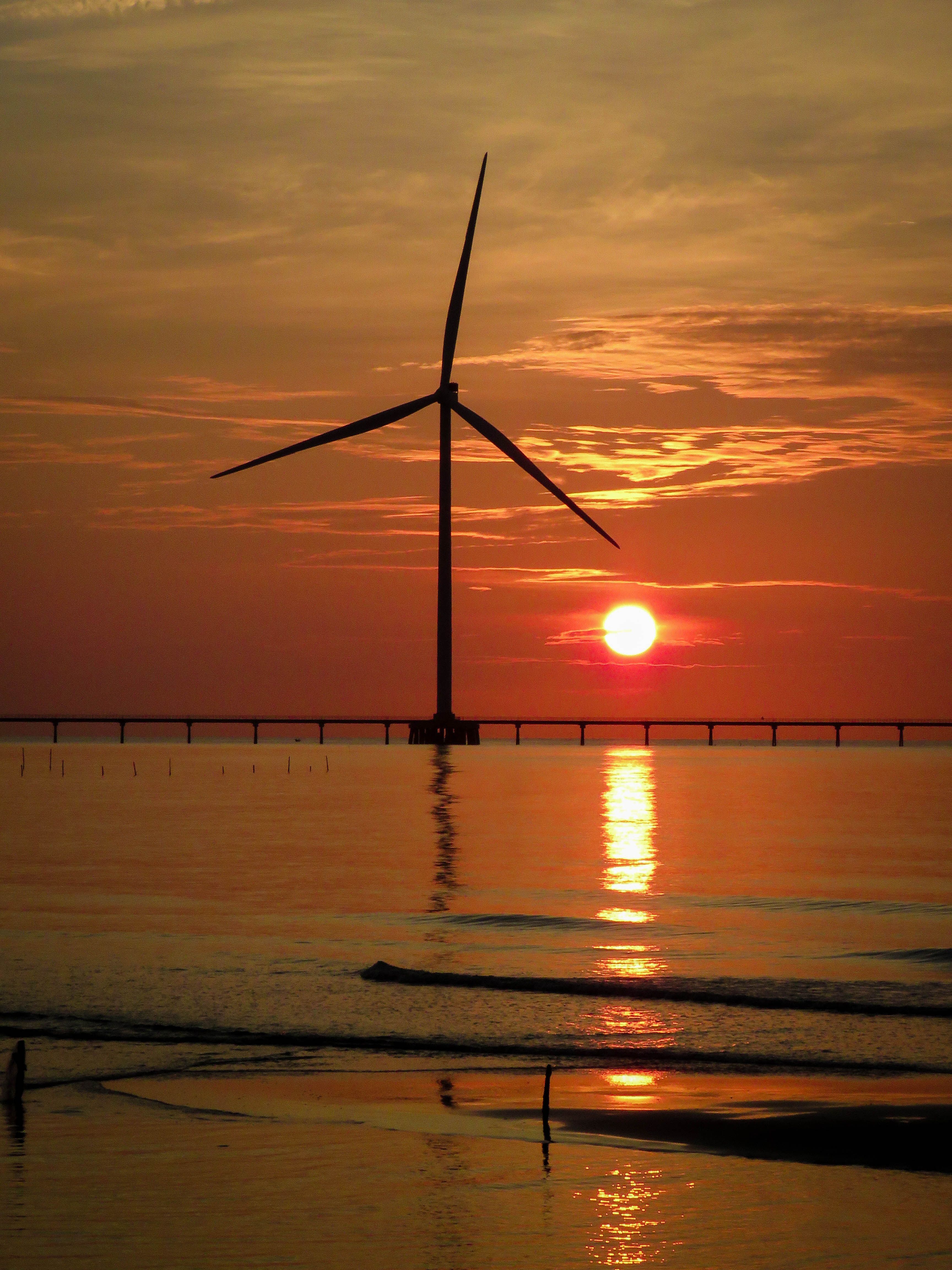 Dramatic Sunset Behind a Wind Turbine · Free Stock Photo