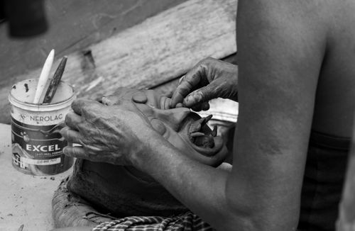 Free An artisan skillfully sculpts a clay idol in Kumartuli, Kolkata, India. Stock Photo