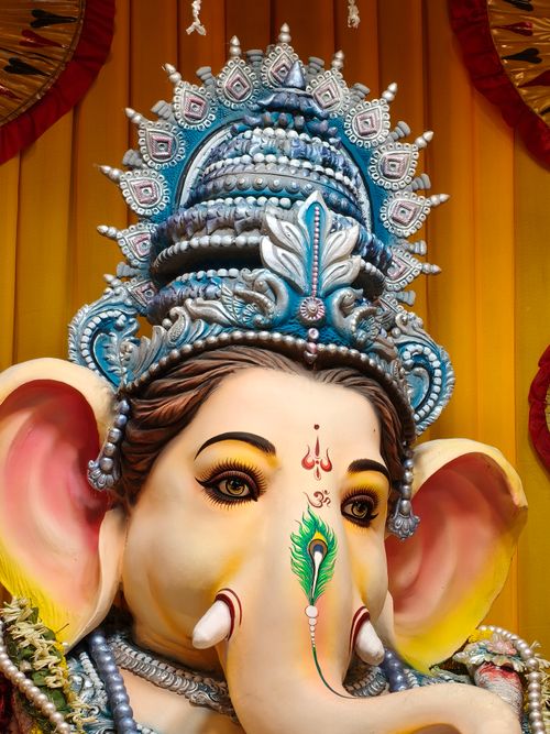 Free Stunningly detailed Ganesh idol adorned with ornate jewelry and vibrant colors. Stock Photo
