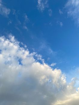 A mesmerizing capture of a blue sky filled with fluffy white clouds, creating a tranquil scene.