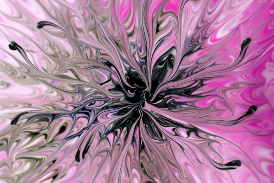 Captivating abstract art with pink and black swirling patterns, creating a floral-like explosion effect.