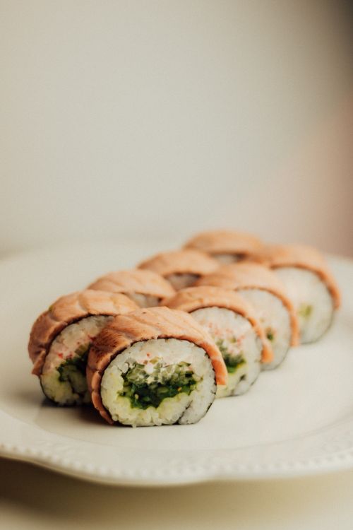 Free Tasty sushi rolls with a salmon topping, ideal for Japanese cuisine lovers. Stock Photo