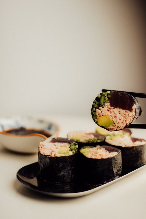 Free Appetizing sushi rolls on a plate with chopsticks, ideal for culinary themes. Stock Photo