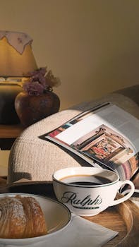Relaxing indoors with a coffee, pastry, and magazine. Perfect cozy and serene setting for a peaceful morning.