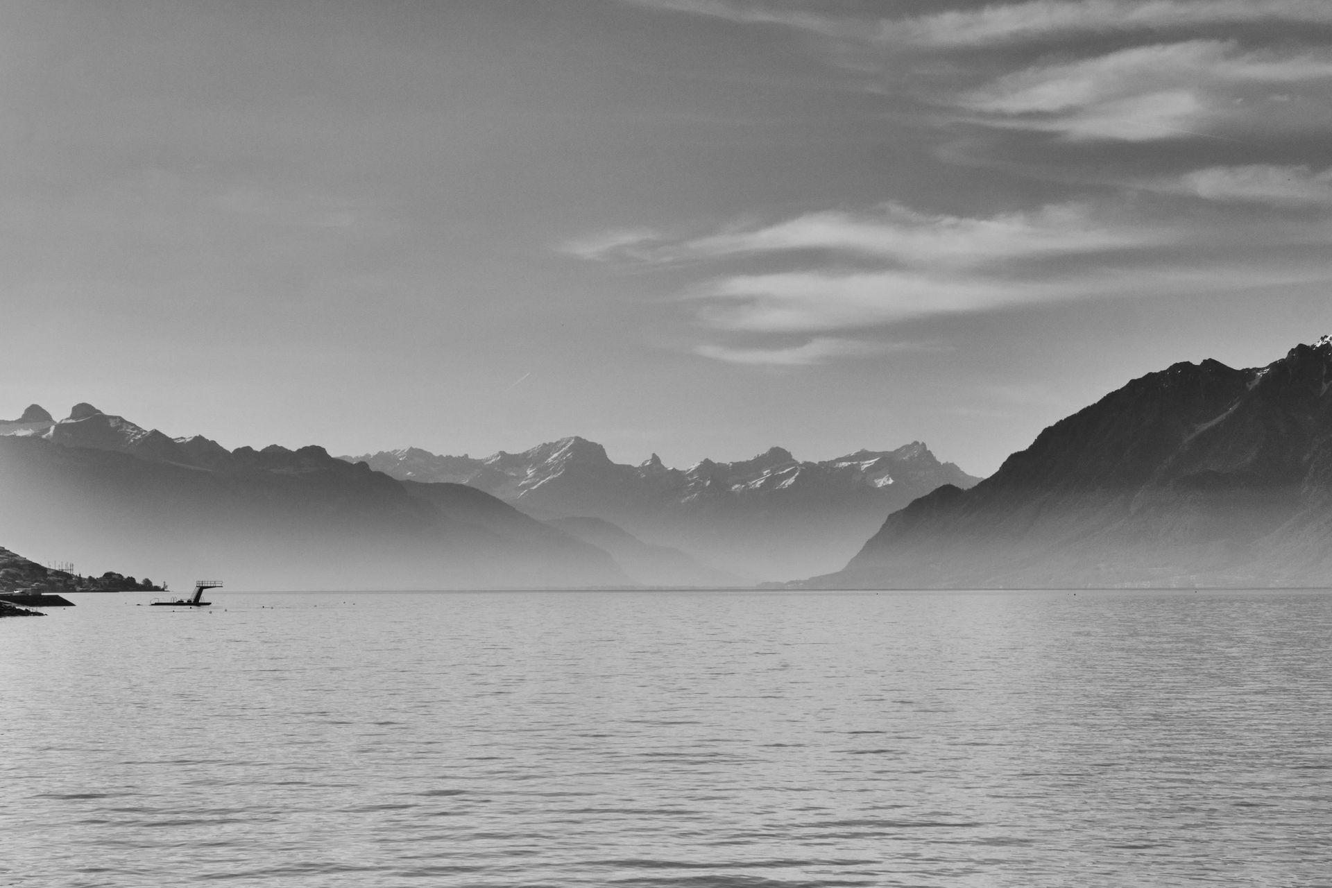 Geneva, Switzerland with lake and mountains in calm daylight