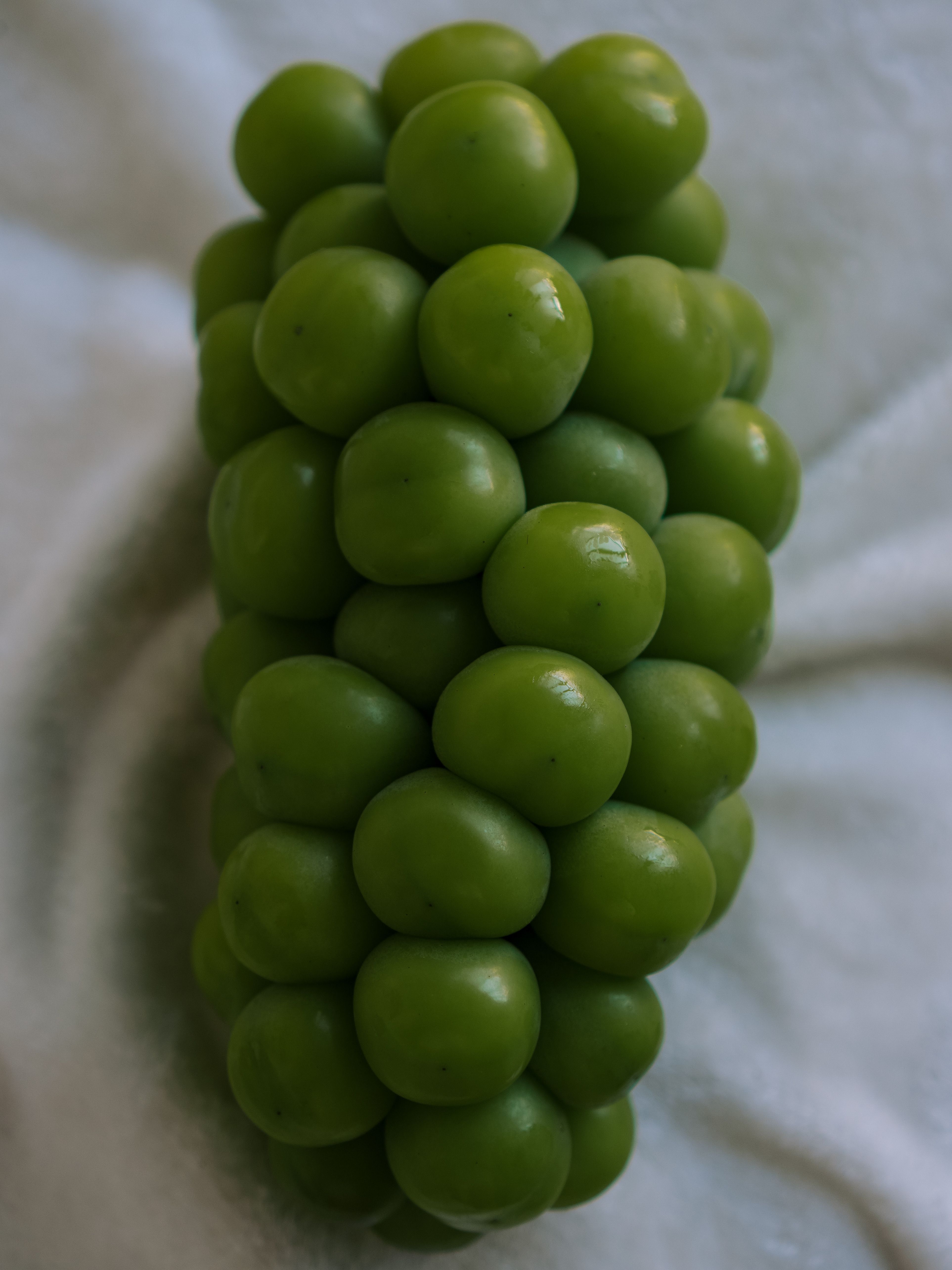 Close-Up of Fresh Green Grapes on Soft Fabric · Free Stock Photo