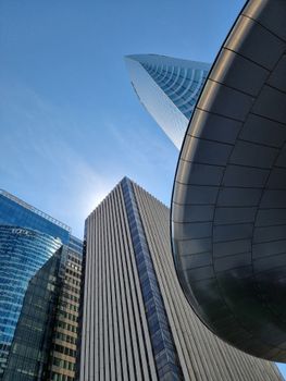 Futuristic architectural design of skyscrapers in La Défense, Paris during daylight.