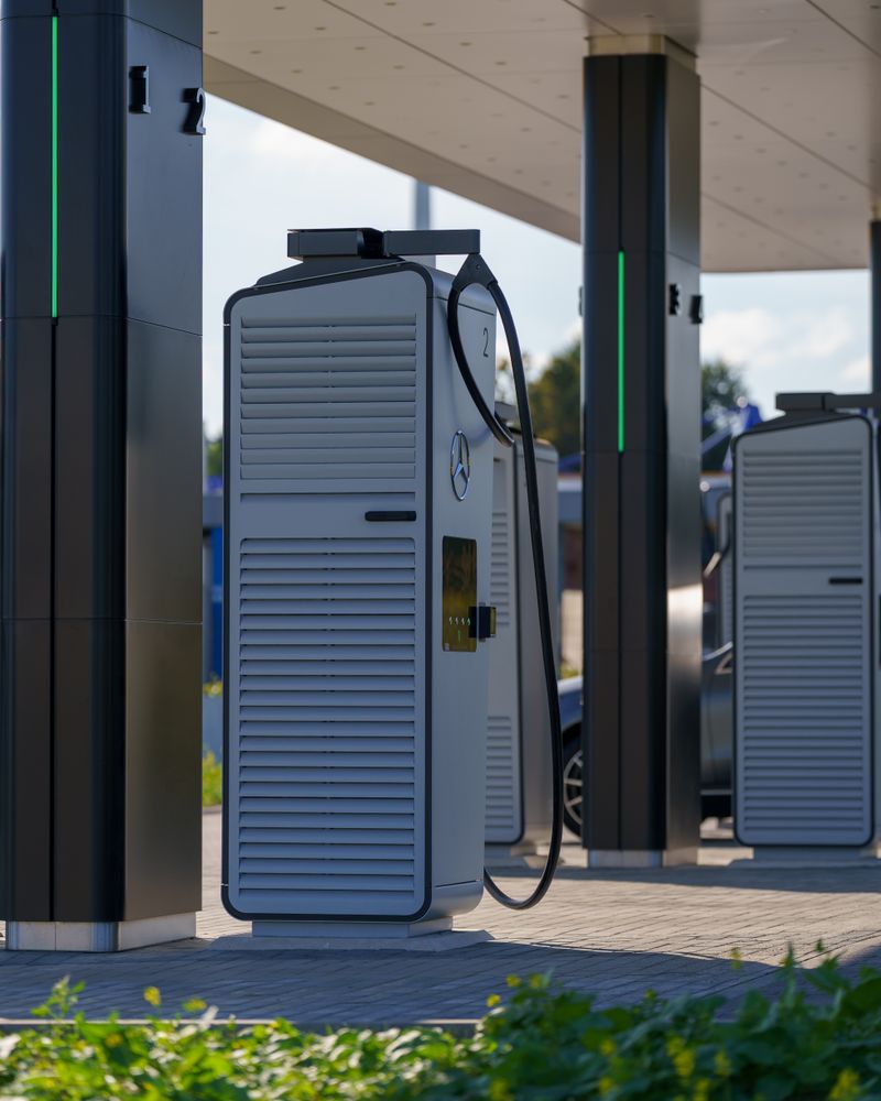 Modern electric vehicle charging station outdoors with multiple charging units under a canopy