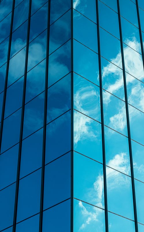 Free Reflection of clouds on a modern glass office building in Vilnius, Lithuania. Stock Photo