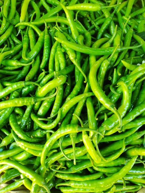 Free A vibrant collection of fresh green chili peppers, showcasing their vivid color and texture. Stock Photo